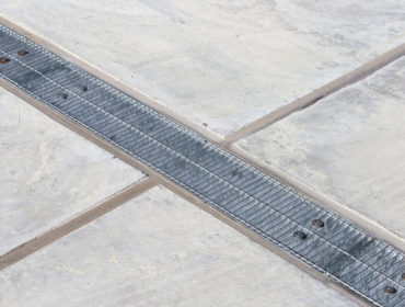 concrete garage floor drains properly